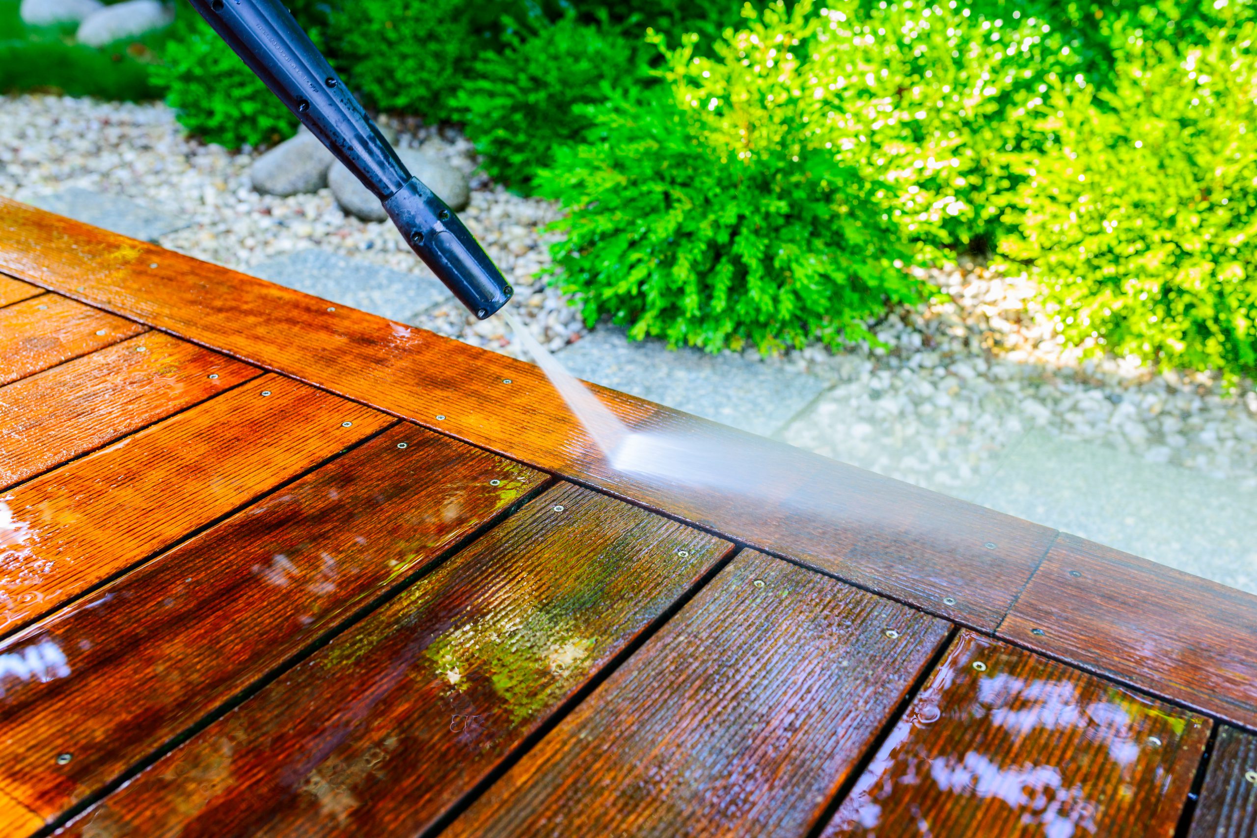 a deck being power washed by a professional