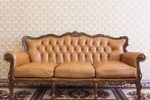 vintage couch in front of wallpaper
