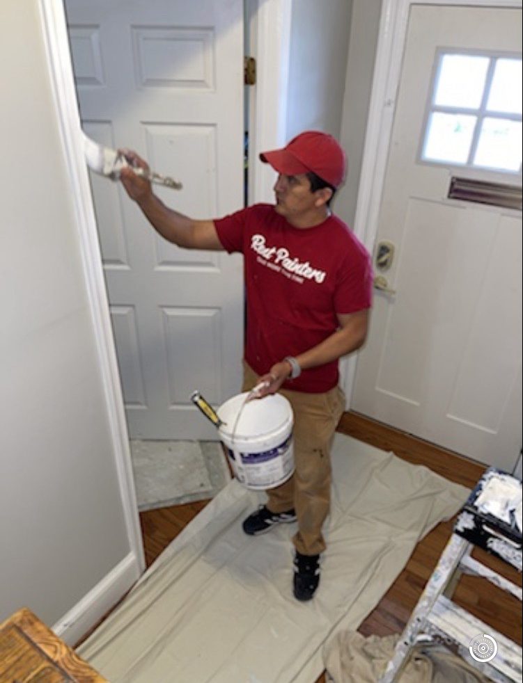 Rent Painters painter painting white trim on a door frame