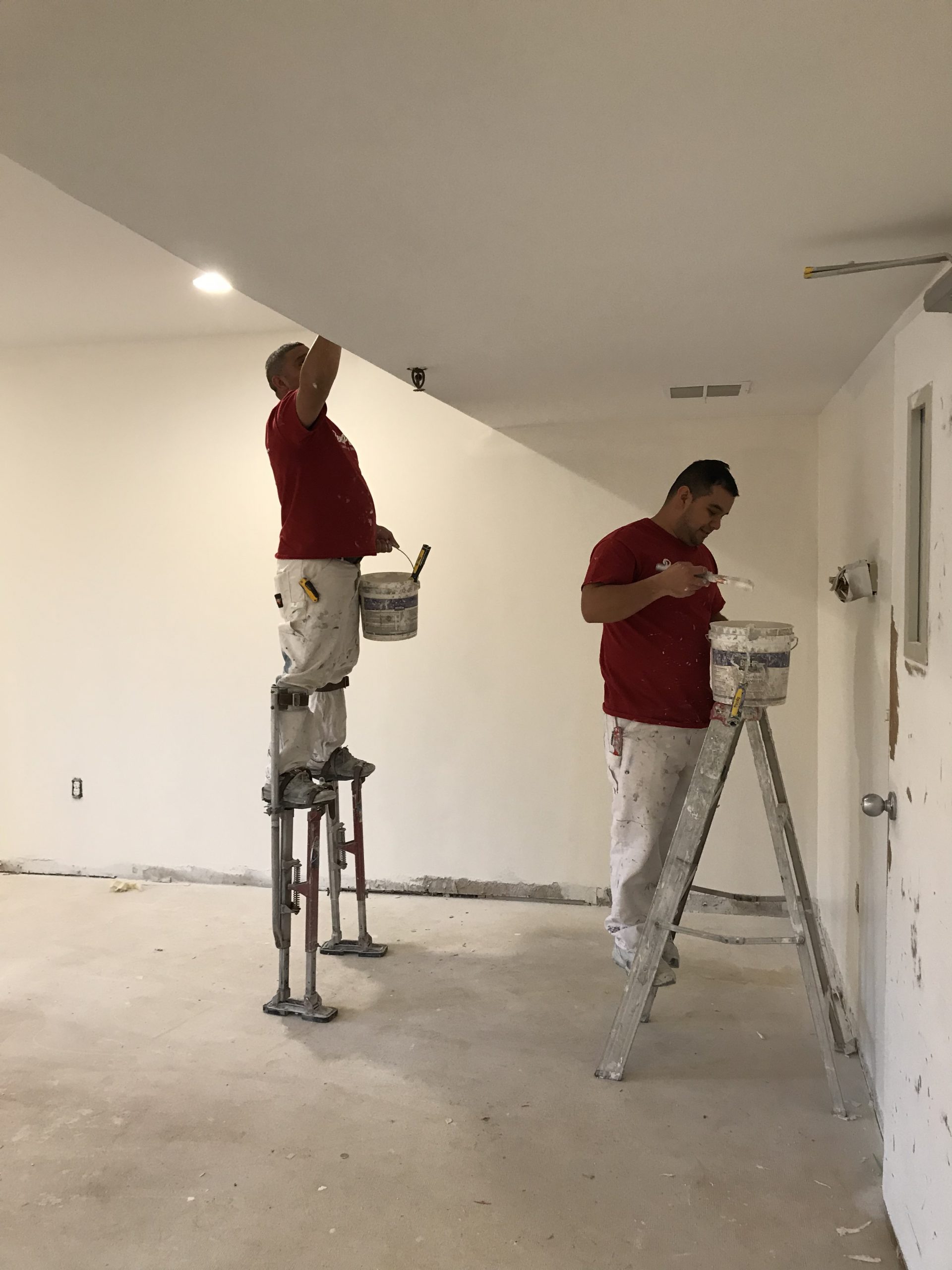 two Rent Painters employees painting a room