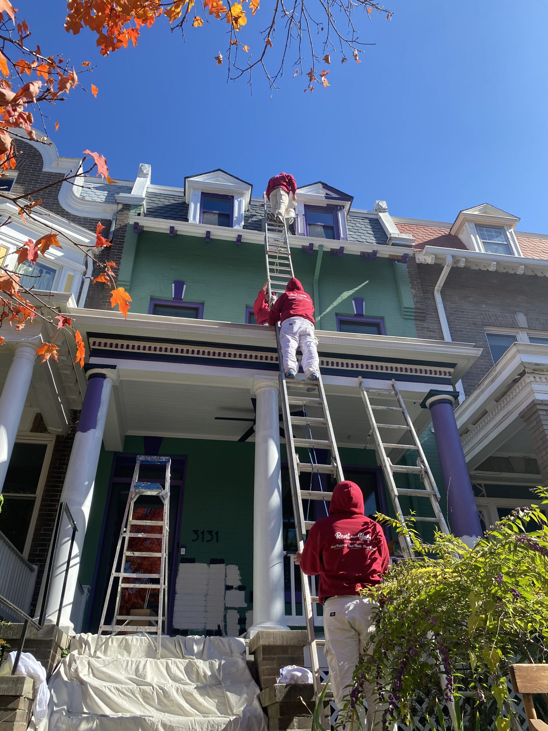 Rent Painters painting the exterior of a home green and purple