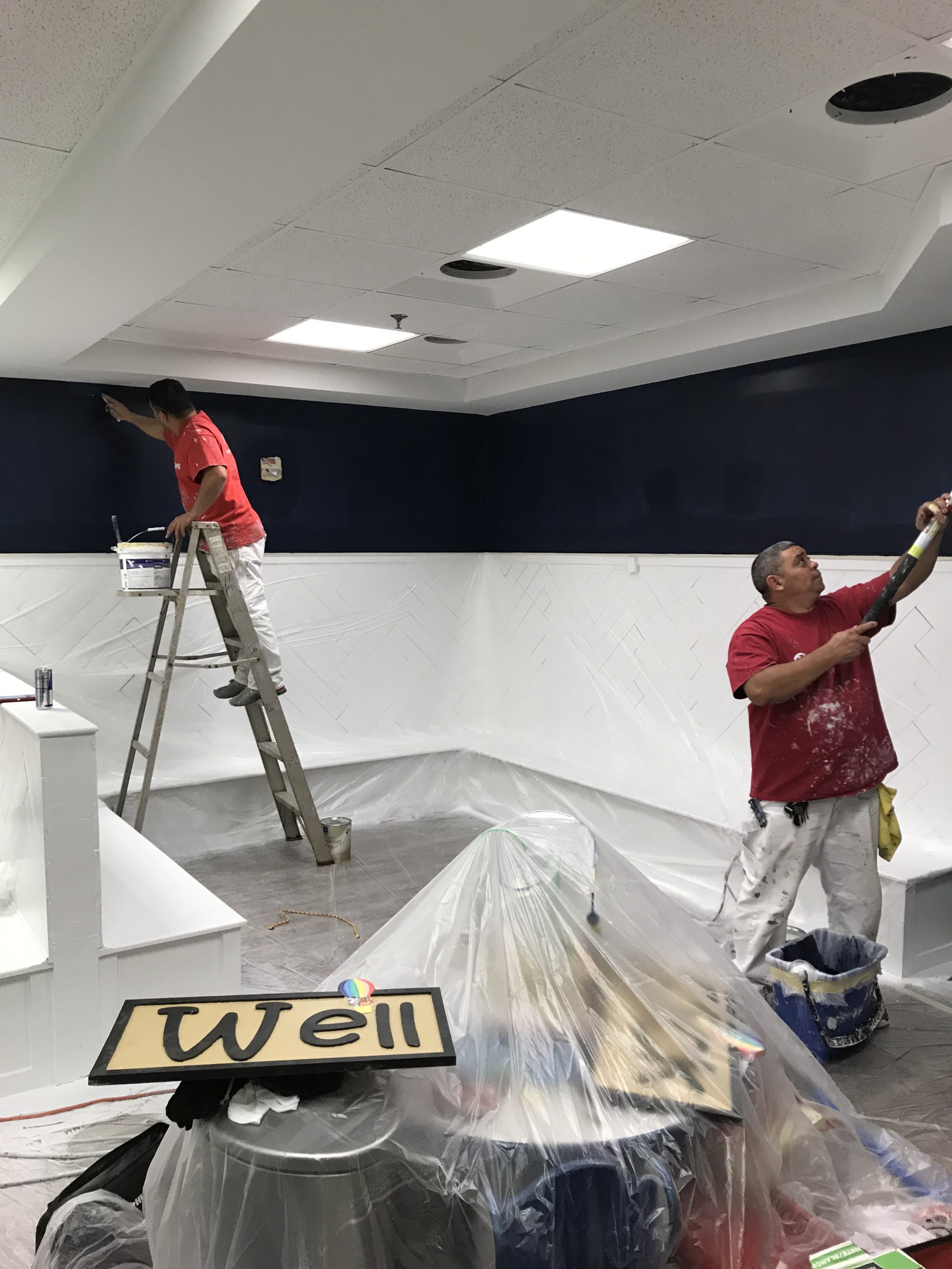 Rent Painters painting a wall navy and white